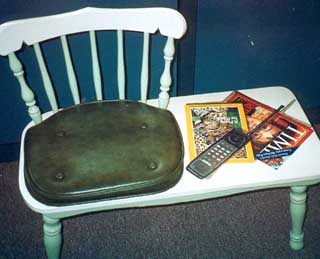 Trompe L'oeil of magazines & telephone, acrylic on wooden bench.